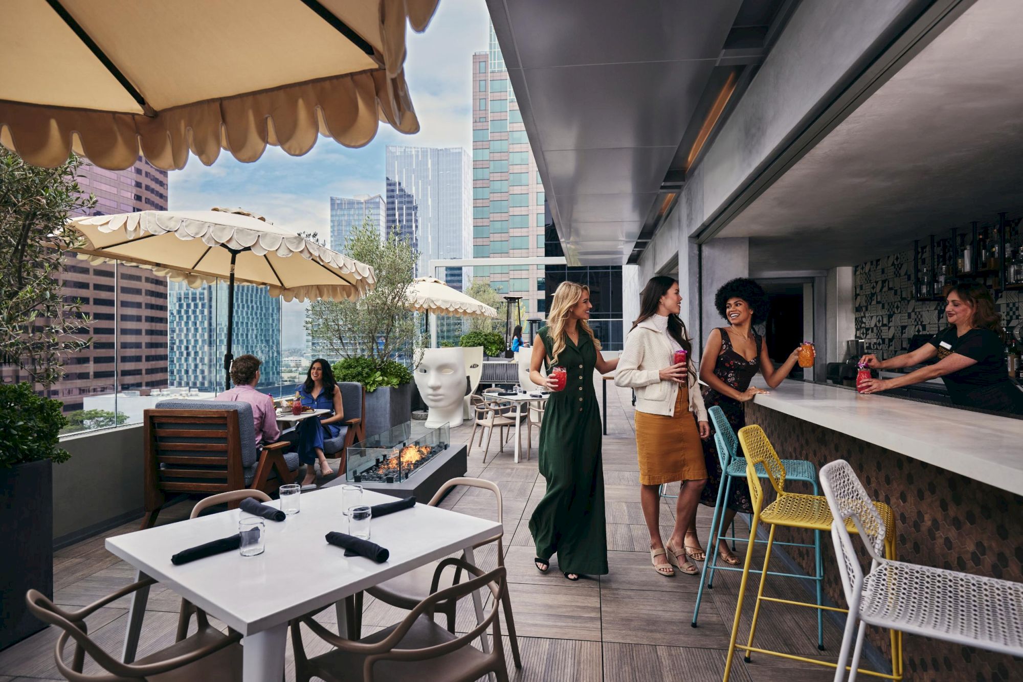 A stylish rooftop bar with modern seating, umbrellas, and city skyline; people chat, a bartender serves, chic dress code, sunny and vibrant.